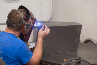 Actron employee welding